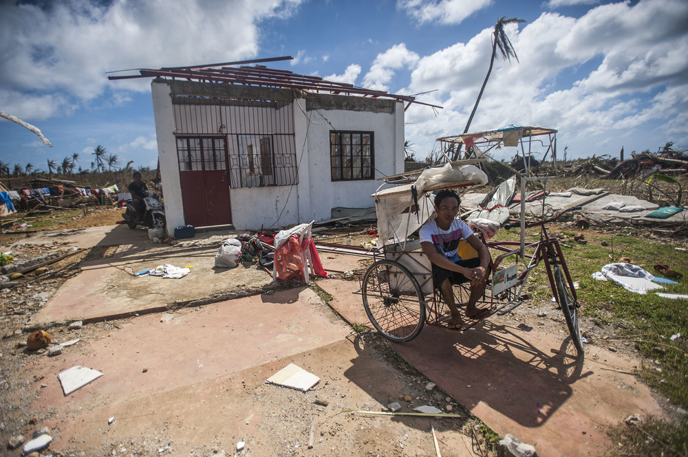 131115-N-BD107-722 / Kennedy, Liam, MCSN 131115-N-BD107-722 GUIUAN, Eastern Samar Province, Republic of the Philippines (Nov. 15, 2013) A Guiuan resident sits in a ricksha outside of his ruined home in the aftermath of Super Typhoon Haiyan. The George Washington Carrier Strike Group support